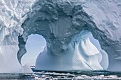 Huge arched iceberg near Petermann Island, western side of the Antarctic Peninsula, Southern Ocean, Polar Regions