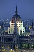 The dome and spires of the Parliament Building illuminated at dusk in Budapest, UNESCO World Heritage Site, Hungary, Europe