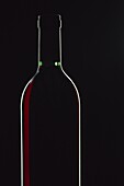 Backlit shot of a bottle of red wine