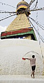 Repainting Boudha, the Buddhist stupa at Boudhanath (Bodhanath) with a coat of limewash, UNESCO World Heritage Site, Kathmandu, Nepal, Asia