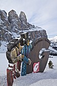 Snow covered Val Gardena sign in front of Mount Langkofel, Sella Ronda, South Tyrol, Dolomites, Italy, Europe