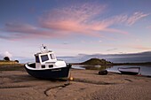 Fishing boat on the Aln Estuary at twilight, low tide, Alnmouth, near Alnwick, Northumberland, England, United Kingdom, Europe