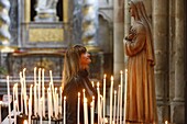 Woman praying to Santa Rita, Amiens Cathedral, Somme, France, Europe
