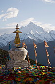 Buddhist stupa with Meili Snow Mountain peak in background, en route to the Tibetan border, Deqin, Shangri-La region, Yunnan Province, China, Asia