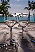Wine glasses in front of the pool of the Beachcomber Le Paradis, Mauritius, Indian Ocean, Africa