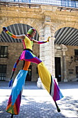 Performer in the street in Old Havana walking on stilts, Havana, Cuba, West Indies, Central America