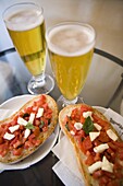 Snack of beer and bruschetta in cafe, Siena, Tuscany, Italy, Europe