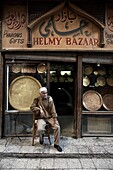 Shop owner relaxes in the great bazaar of Khan al-Khalili, Cairo, Egypt, Africa