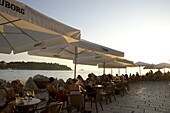 People enjoying sunset at outdoor cafes in Rovinj, Istria, Croatia, Adriatic, Europe