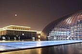 Full moon above Soviet style Great Hall of the People contrasts with The National Theatre Opera House, also known as The Egg designed by French architect Paul Andreu and made with glass and titanium opened 2007, Beijing, China, Asia