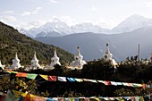 Buddhist stupas with Meili Snow Mountain peak in background, en route to the Tibetan border, Deqin, Shangri-La region, Yunnan Province, China, Asia