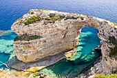 A view of the Trypitos Arch on the south coast of Paxos, Ionian Islands, Greek Islands, Greece, Europe