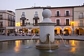 Fountain in the illuminated Plaza Mayor at dusk, Trujillo, Caceres, Extremadura, Spain, Europe