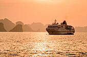 Expedition cruise ship MS Hanseatic (Hapag-Lloyd Cruises) and Ha Long Bay islands at sunset, Ha Long Bay, Quang Ninh Province, Vietnam, Asia