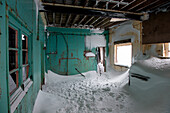Icy scenes of an abandoned past at old whaling station – here the rooms connected to the airplane hanger, Whalers Bay, Deception Island, South Shetland Islands, Antarctica