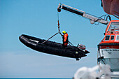 Zodiac dinghy is lowered from expedition cruise ship MS Hanseatic (Hapag-Lloyd Cruises), Grytviken, South Georgia Island, Antarctica