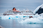 Ice floes and Zodiac dinghy from expedition cruise ship MS Hanseatic (Hapag-Lloyd Cruises), Neko Harbour, Graham Land, Antarctica
