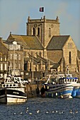 Harbour and fishing boats with houses and church in the background, Barfleur, Manche, Normandy, France, Europe