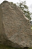 Runic stone, raised by Harald Bluetooth in 959AD to commemorate bringing Christianity to Denmark, the stone is called Denmark's certificate of baptism, outside Jelling church, Jutland, Denmark, Scandinavia, Europe