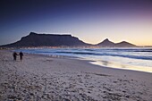 People walking on Milnerton beach with Table Mountain in background, Cape Town, Western Cape, South Africa, Africa