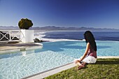Woman relaxing poolside at Plettenberg Bay Hotel, Plettenberg Bay, Western Cape, South Africa, Africa