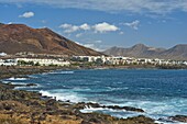The rocky west extremity of the sea front at the popular resort of Playa Blanca on the far south coast, Playa Blanca, Lanzarote, Canary Islands, Spain, Atlantic, Europe