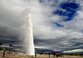 Strokkur at full height, the powerful geyser that erupts every 10 minutes, beside the now-inactive Geysir, southeast Iceland, Iceland, Polar Regions