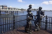 People Like Us, bronze sculpture of a young local couple with their dog, by John Clinch, 1993, Mermaid Quay, Cardiff Bay, South Glamorgan, Wales, United Kingdom, Europe