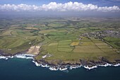 Aerial view of Poldhu Cove and Mullion, looking east to Goonhilly, Lizard Peninsula, in summer sun, Cornwall, England, United Kingdom, Europe