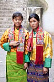 Two young woman in colourful national dress at the Wangdue Phodrang Tsechu, Wangdue Phodrang Dzong, Wangdue Phodrang (Wangdi), Bhutan, Asia