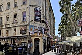 Posters advertising the theatre festival on a building with pictures painted on the windows, Avignon, Provence, France, Europe