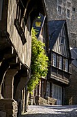 Medieval corbelled and half timbered mansions in cobbled street, Old Town, Dinan, Brittany, Cotes d'Armor, France, Europe