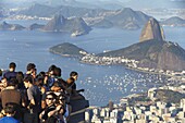 Tourists enjoying view of Sugar Loaf Mountain (Pao de Acucar) and Botafogo Bay from Corvocado, Rio de Janeiro, Brazil, South America