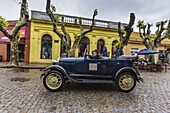 Old car used as taxi on cobblestone street in Colonia del Sacramento, Uruguay, South America