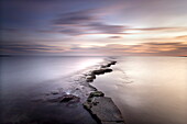 Kimmeridge Bay at dusk showing wave-cut platform known locally as The Flats, Perbeck District, Dorset, England, United Kingdom, Europe