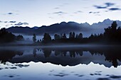 Lake Matheson at night reflecting a near perfect image of Mount Tasman, South Island, New Zealand, Pacific