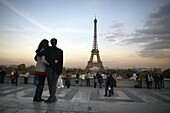 A couple look towards the Eiffel Tower, Paris, France, Europe