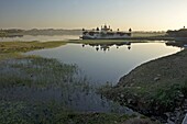 Reflection of temple in lake at sunset, Dungarpur, Rajasthan, India, Asia