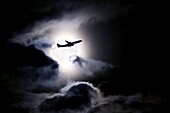 Aircraft taking off from Heathrow passing in front of full moon, London, England, United Kingdom, Europe