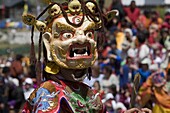 Masked dancer at religious festival with many visitors, Paro Tsechu, Paro, Bhutan, Asia