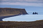 Black sand beach, rock formation and Reynisdrangar sea stacks in the distance, from Dyrholaey near Vik, Iceland, Polar Regions