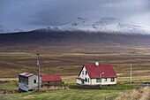 Farm and landscape in Vatsnes Peninsula, with snow-covered mountains in October, north coast of Iceland, Iceland, Polar Regions