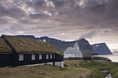 Vidareidi church dating from 1892, and turf-roofed vicarage, Vidoy Island, Nordoyar, Faroe Islands (Faroes), Denmark, Europe