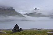 Slaettaratindur peak, highest point in Faroes at 882m, emerging from the mist, Esturoy, Sandoy, Faroe Islands (Faroes), Denmark, Europe