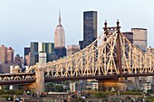 Queensboro Bridge,  Manhattan skyline and the Empire State Building viewed from Queens at dawn,  New York,  United States of America,  North America