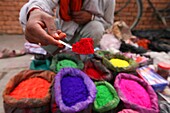 A dye trader offers his brightly coloured wares in a roadside stall in Kathmandu,  Nepal,  Asia