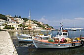 Fishing boats in the harbour in Kassiopi on the northeast coast of Corfu, Ionian Islands, Greek Islands, Greece, Europe