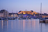 View across the Vieux Port to the illuminated Fort St.-Nicolas at dusk, Marseille, Bouches-du-Rhone, Cote d'Azur, Provence, France, Europe