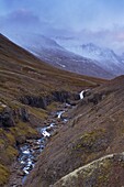 Sunset on snowy mountains in Reydarfjordur fjord, East Fjords, Iceland, Polar Regions