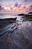 Twilight beside the rocky shore of Trebarwith Strand, Cornwall, England, United Kingdom, Europe